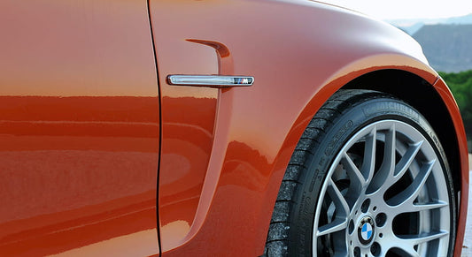 Aftermarket car fenders and components displayed for vehicle upgrade, including front and rear fenders, bumper parts, and replacement car accessories for improved performance and style