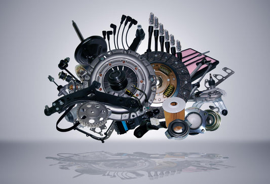 Close-up view of aftermarket small car parts installed on a compact car, showcasing replacement fender liners, headlights, and grille accessories for repair and upgrade
