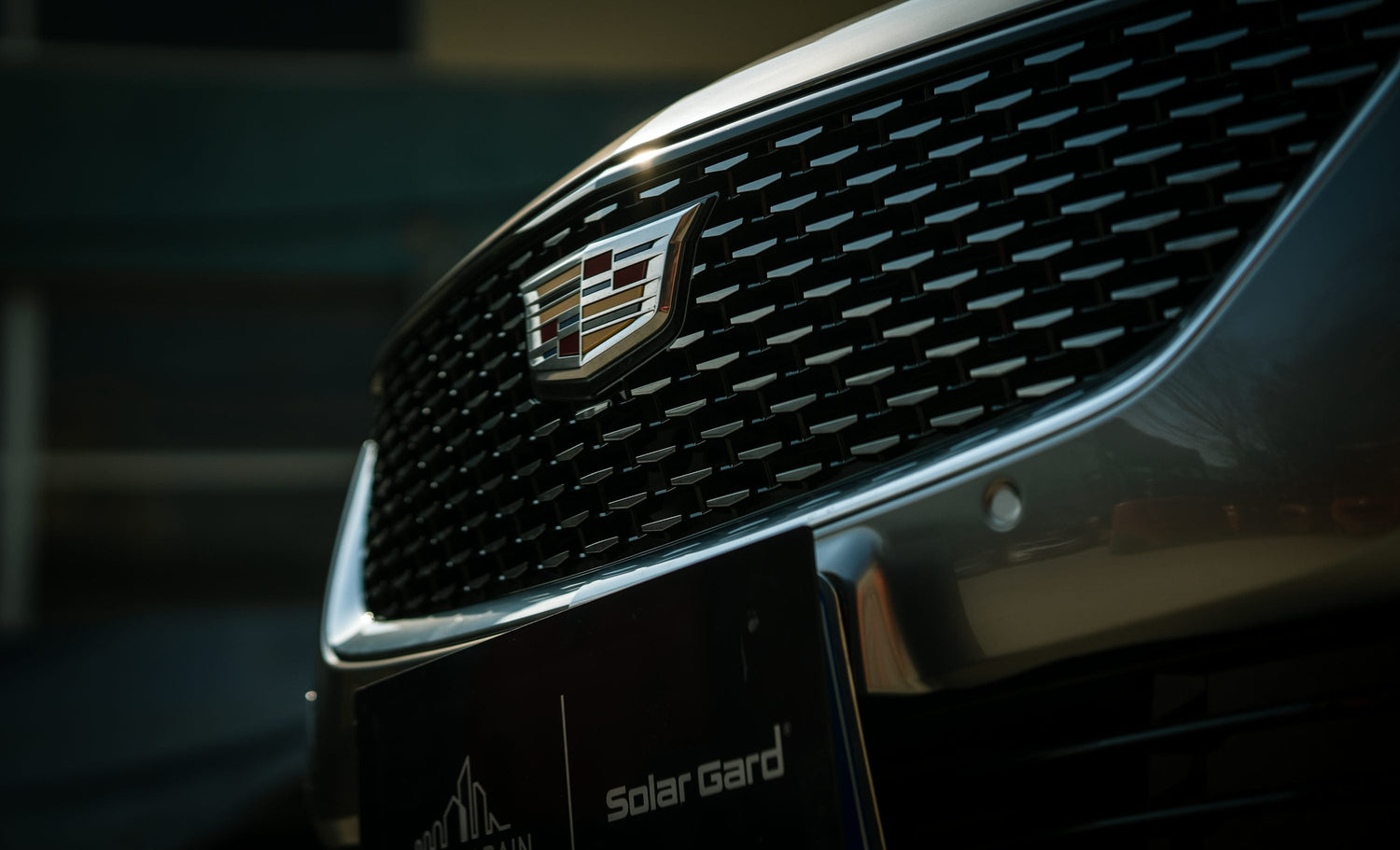 Front view of a car grille assembly showing upper grille, lower grille, honeycomb mesh grille insert, chrome grille surround, grille frame, bumper grille, radiator grille, and air intake grille components for automotive replacement parts